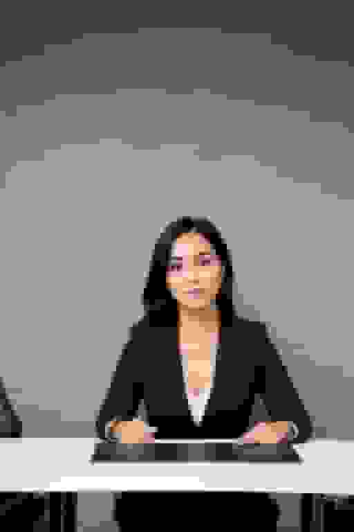professional woman ai headshot Arab woman in her 40s with black hair in a modern boardroom